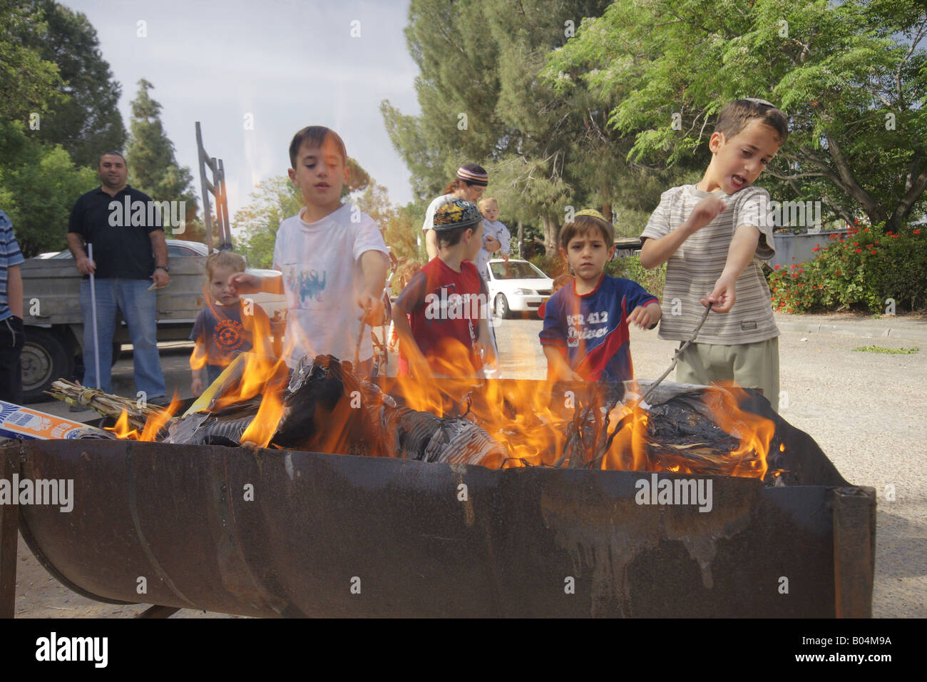 Kids burning bread as part of the preparations for the Passover Holiday