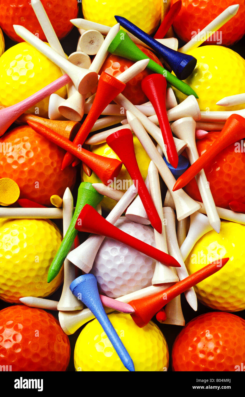 Yellow and orange golf balls with colorful tees Stock Photo Alamy
