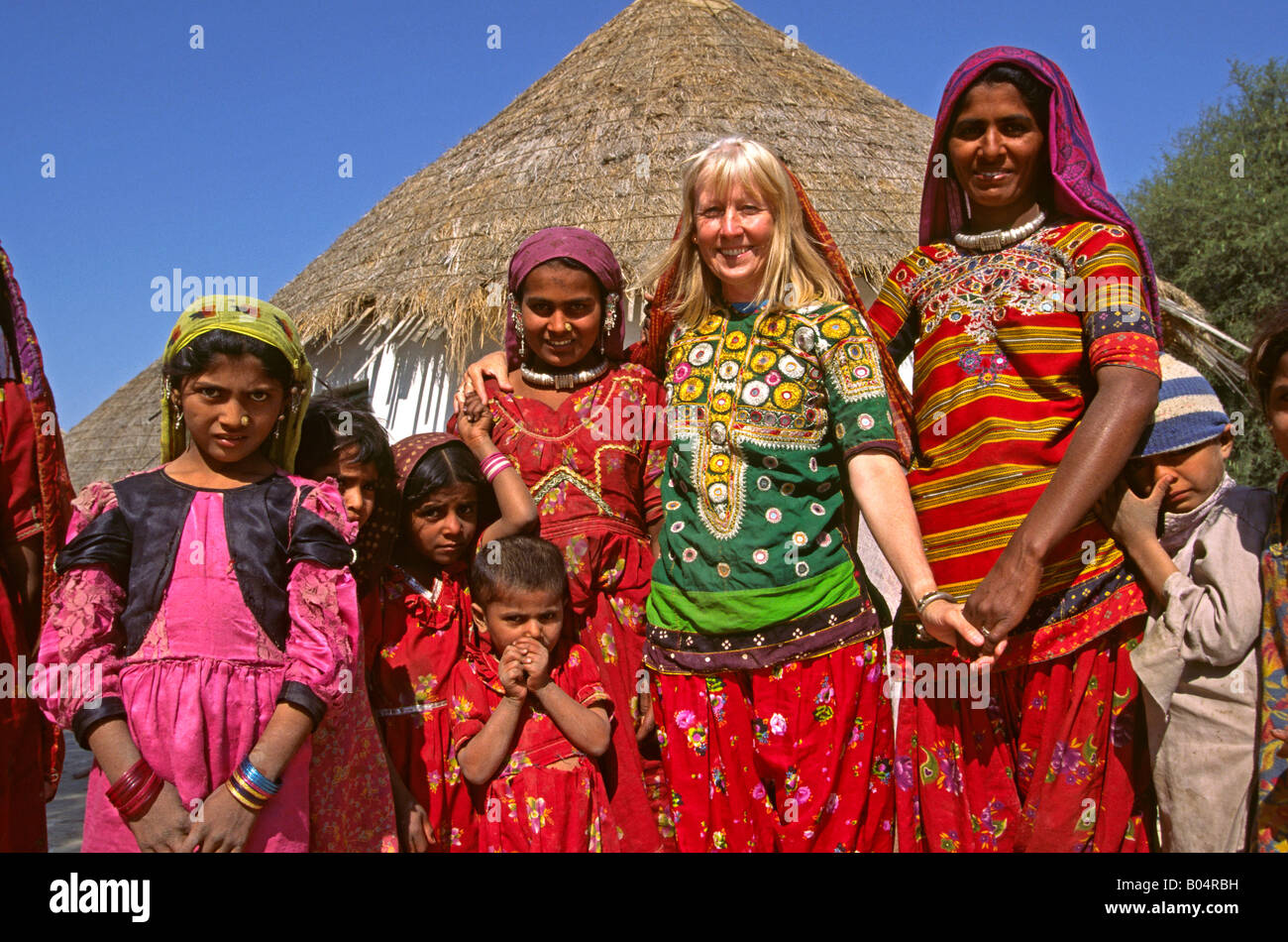 India Rann of Kutch Gujerat Banni area Raisi Putra Moslem people and blonde westerner in their traditional clothes Stock Photo