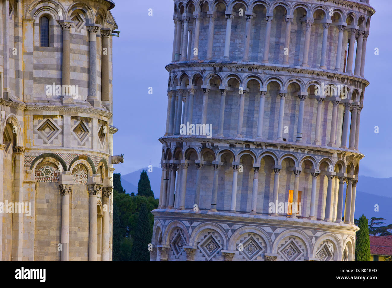 The base of the famous leaning tower of Pisa and Pisa Duomo at dusk in Piazza del Duomo (Campo dei Miracoli) Stock Photo