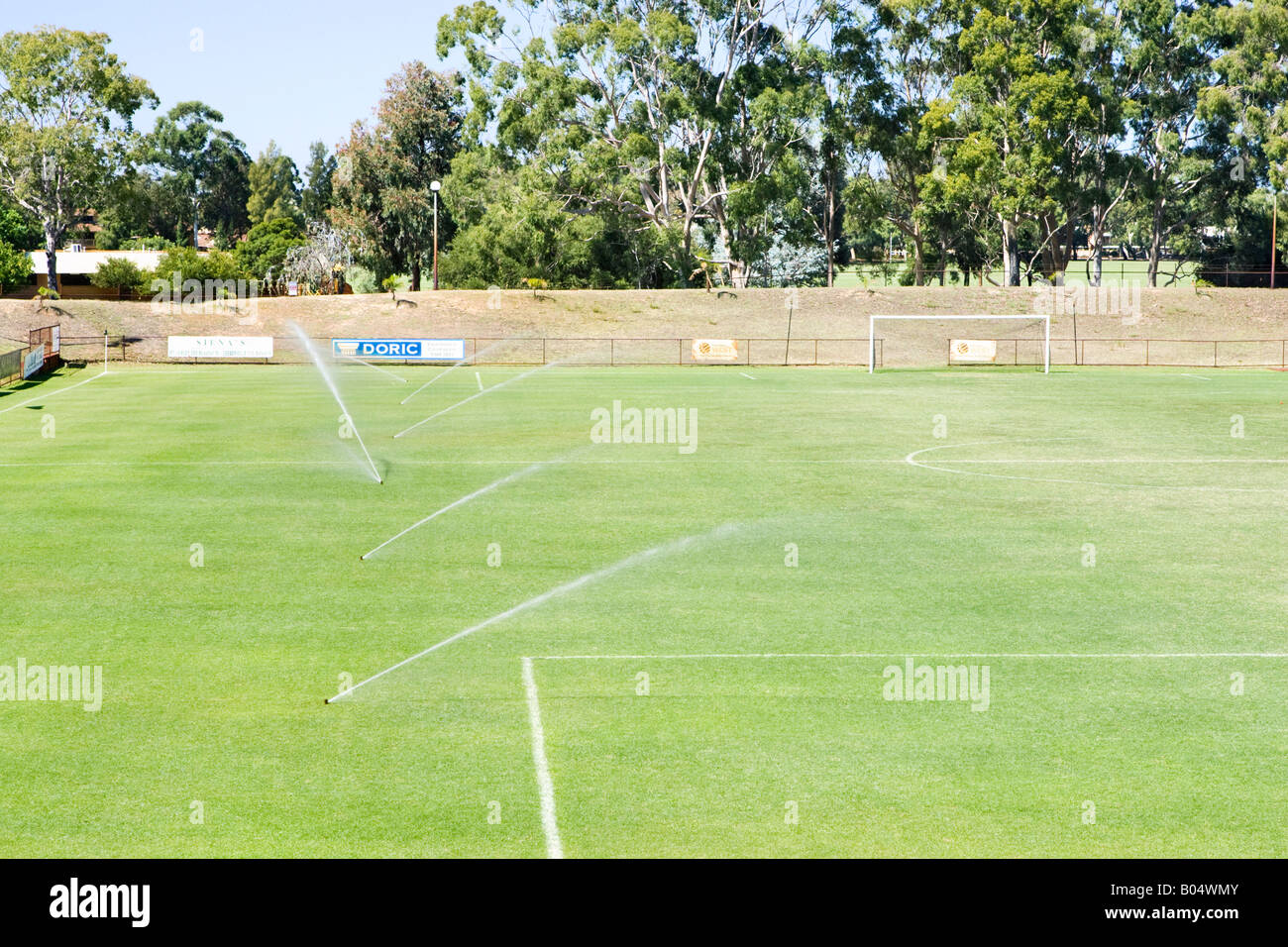 Six irrigation sprinklers watering a football pitch at Litis Stadium in  Leederville, Perth, Western Australia Stock Photo - Alamy
