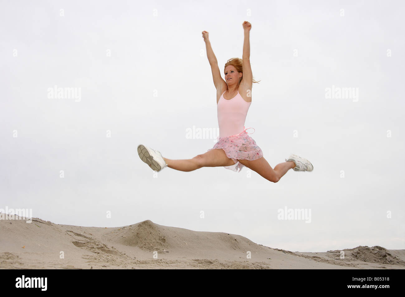 young woman jumps on the beach Stock Photo - Alamy