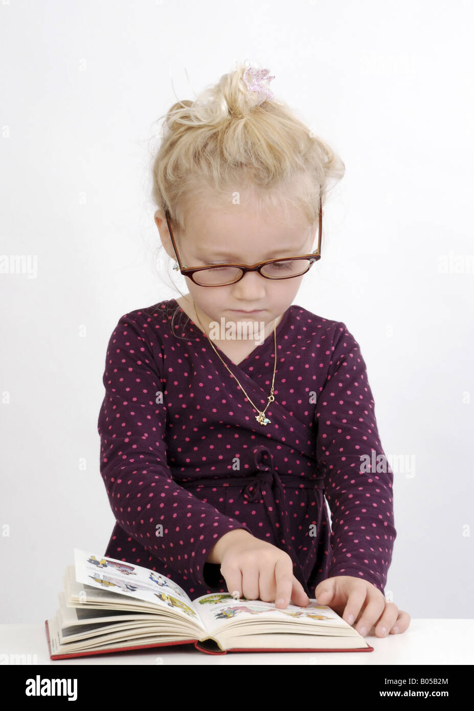 little girl reading a book Stock Photo