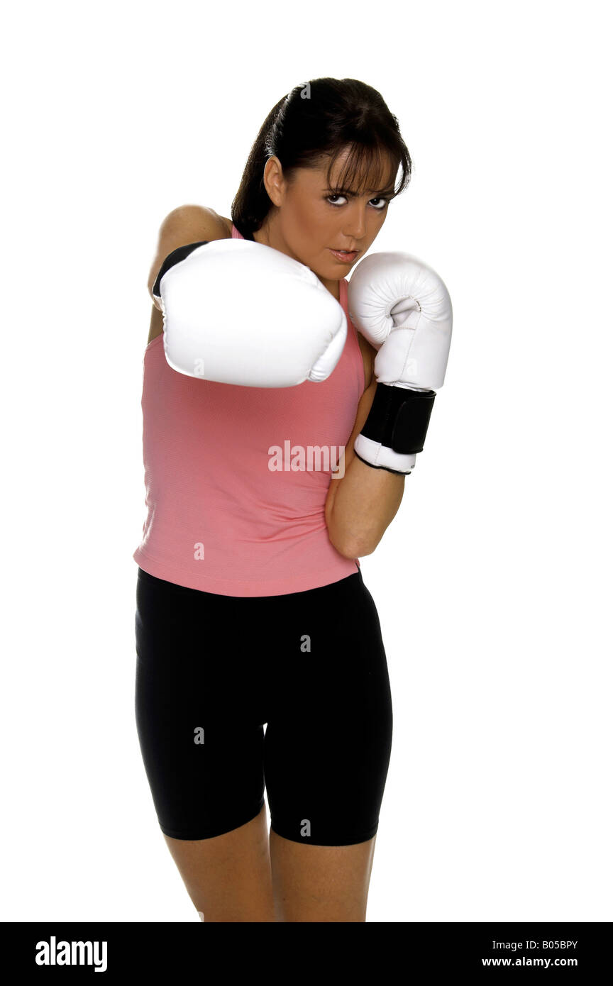 young woman in white boxing gloves shoots a strong right cross during a boxing workout Stock