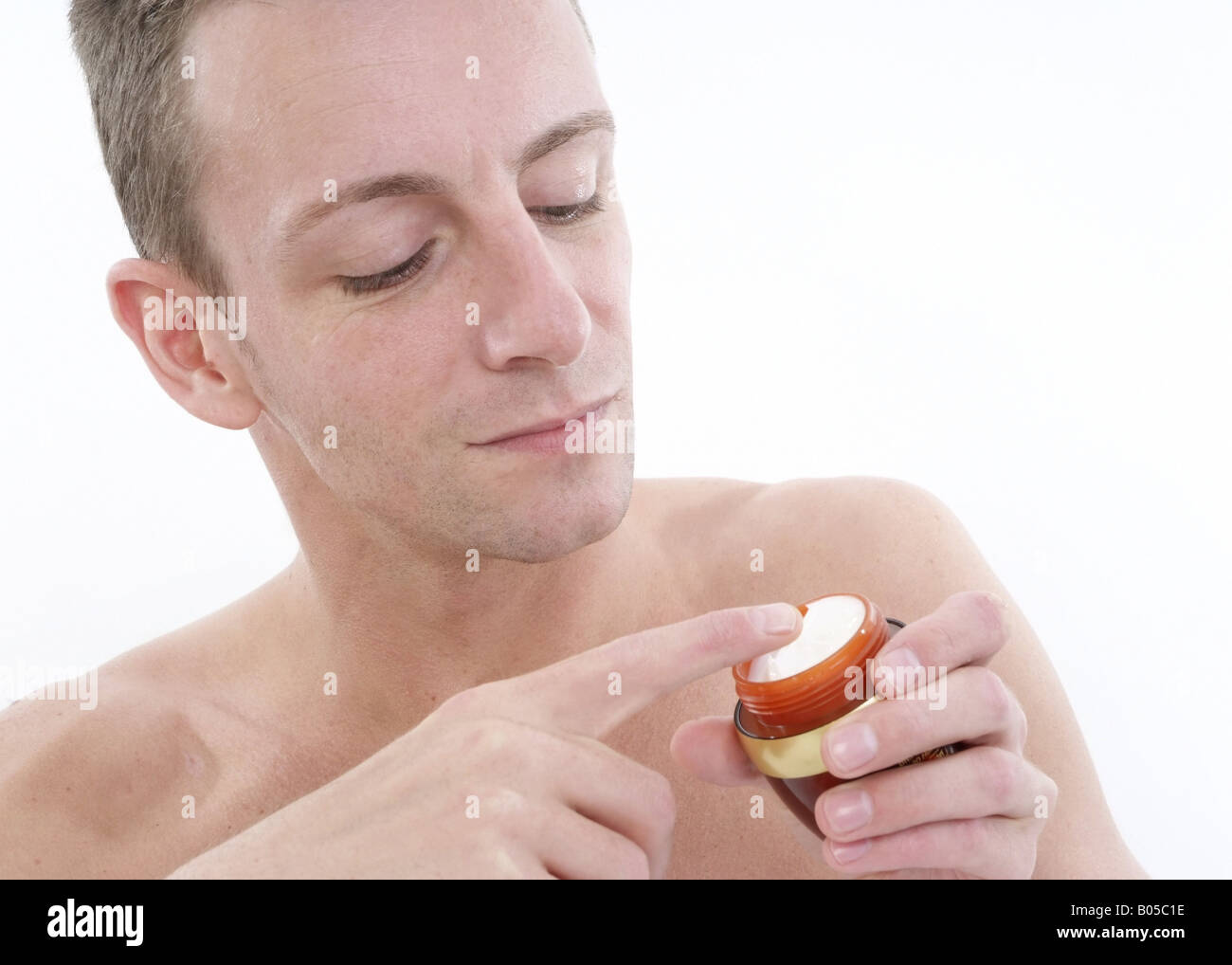young man uses face care Stock Photo