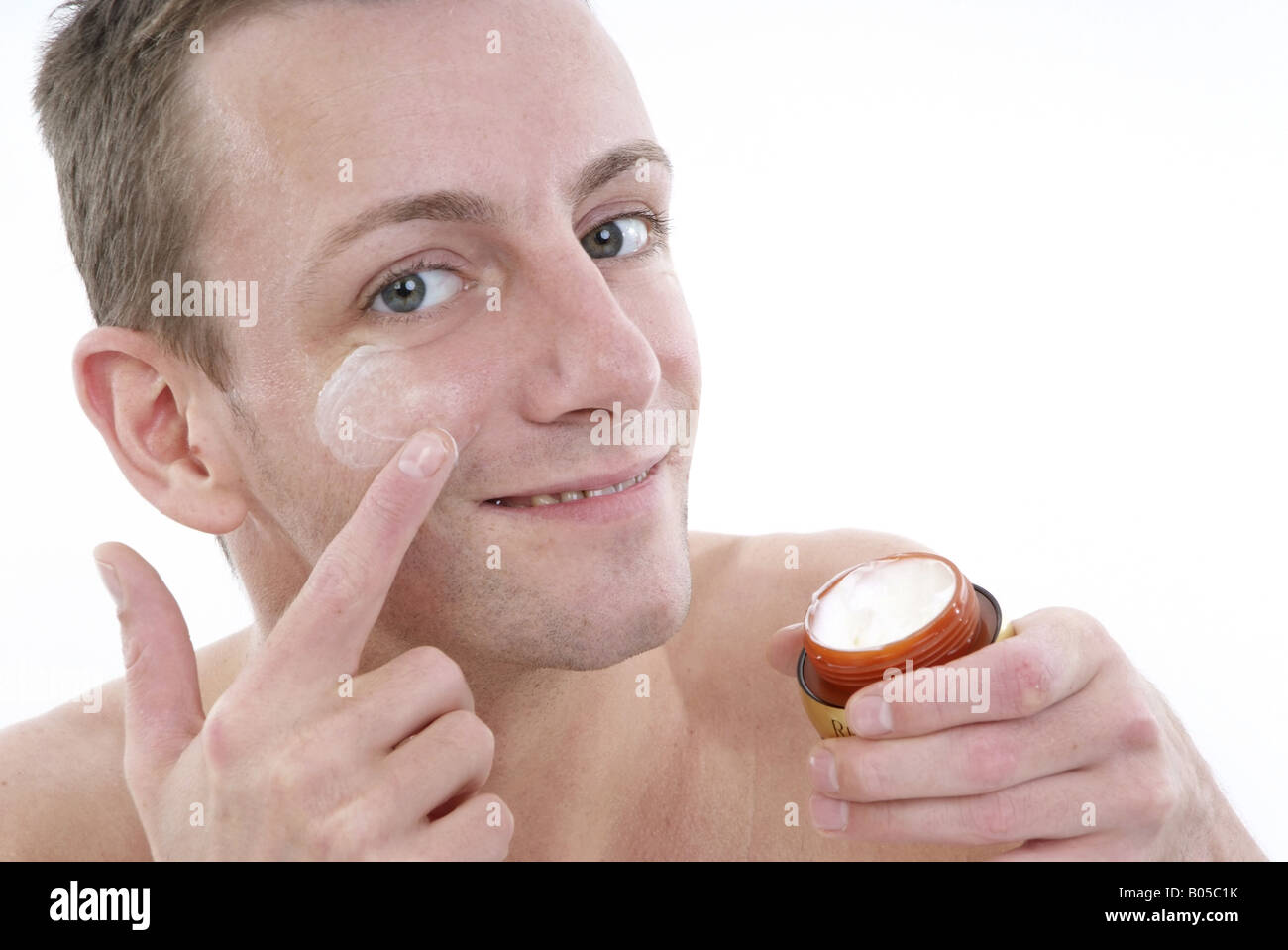 young man uses face care Stock Photo