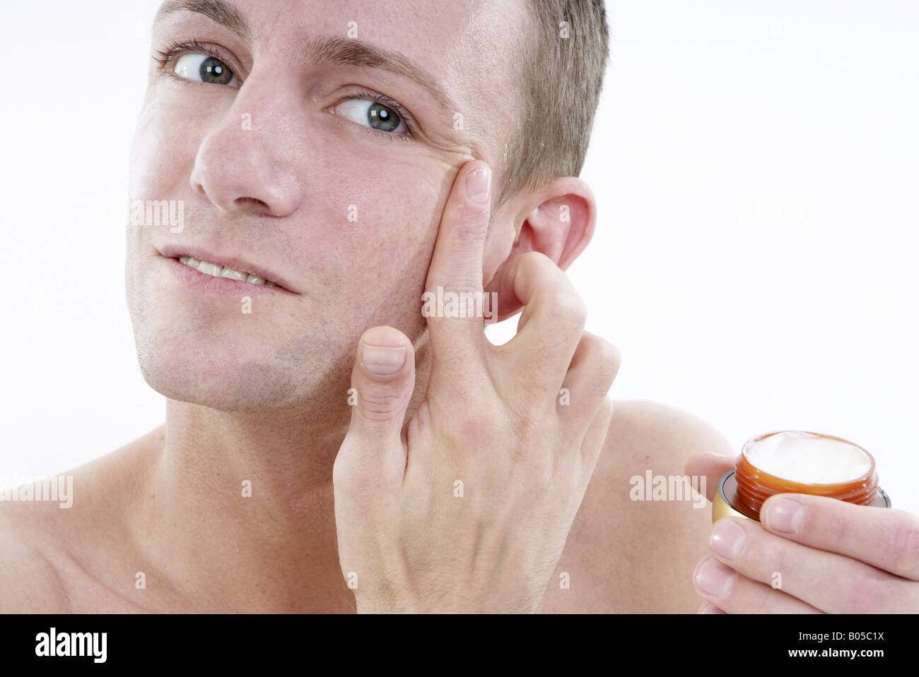 young man uses face care Stock Photo