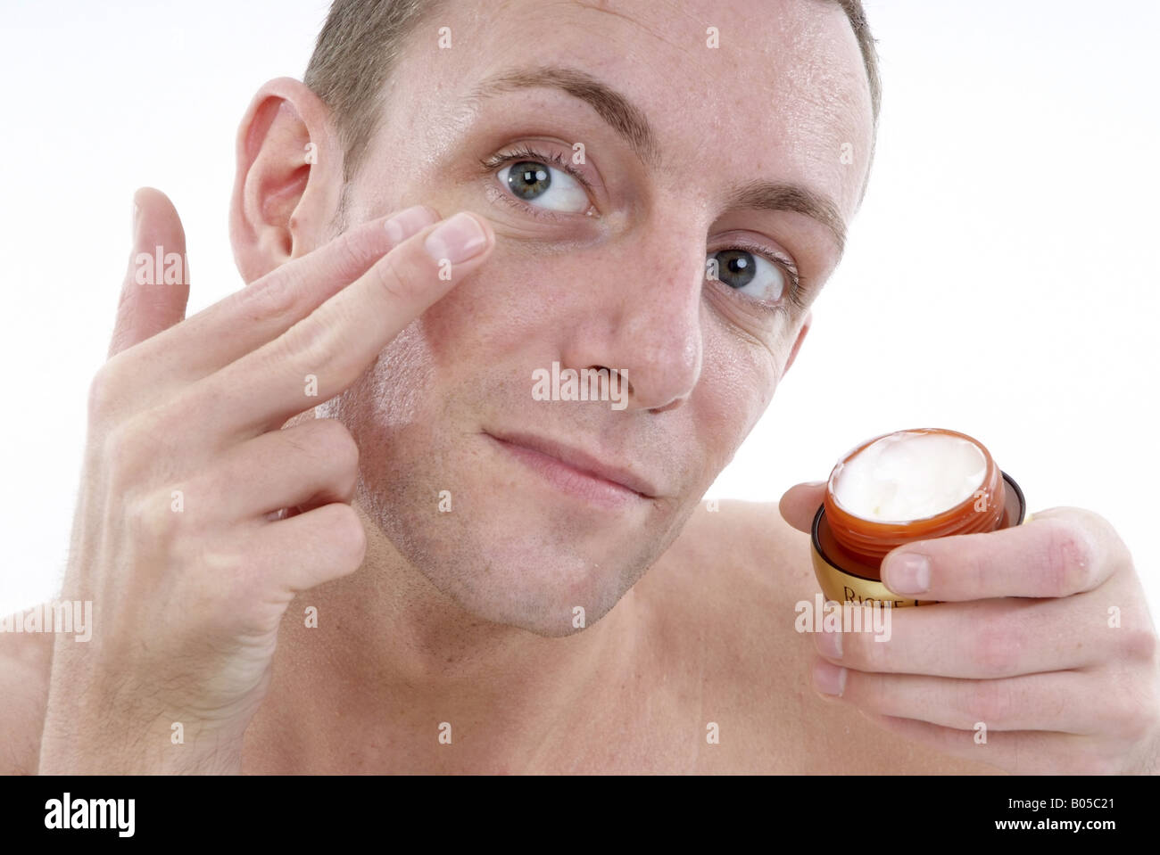 young man uses face care Stock Photo