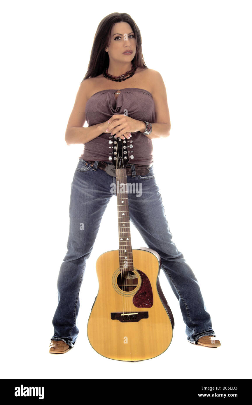 Woman standing with an acoustic guitar Stock Photo - Alamy