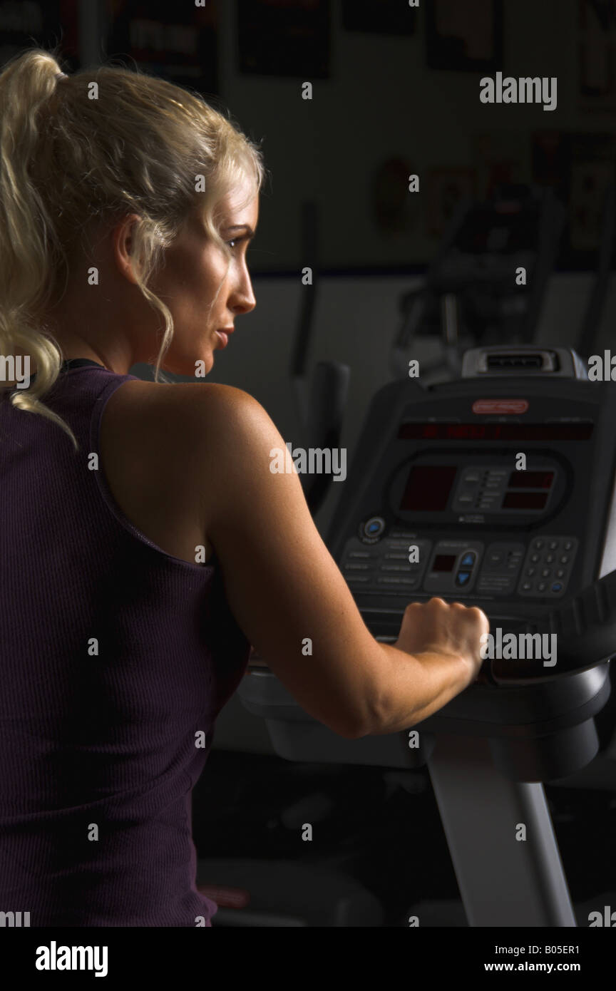 beautiful blond woman during a cardio workout on a recumbant exercise bike in the gym Stock Photo