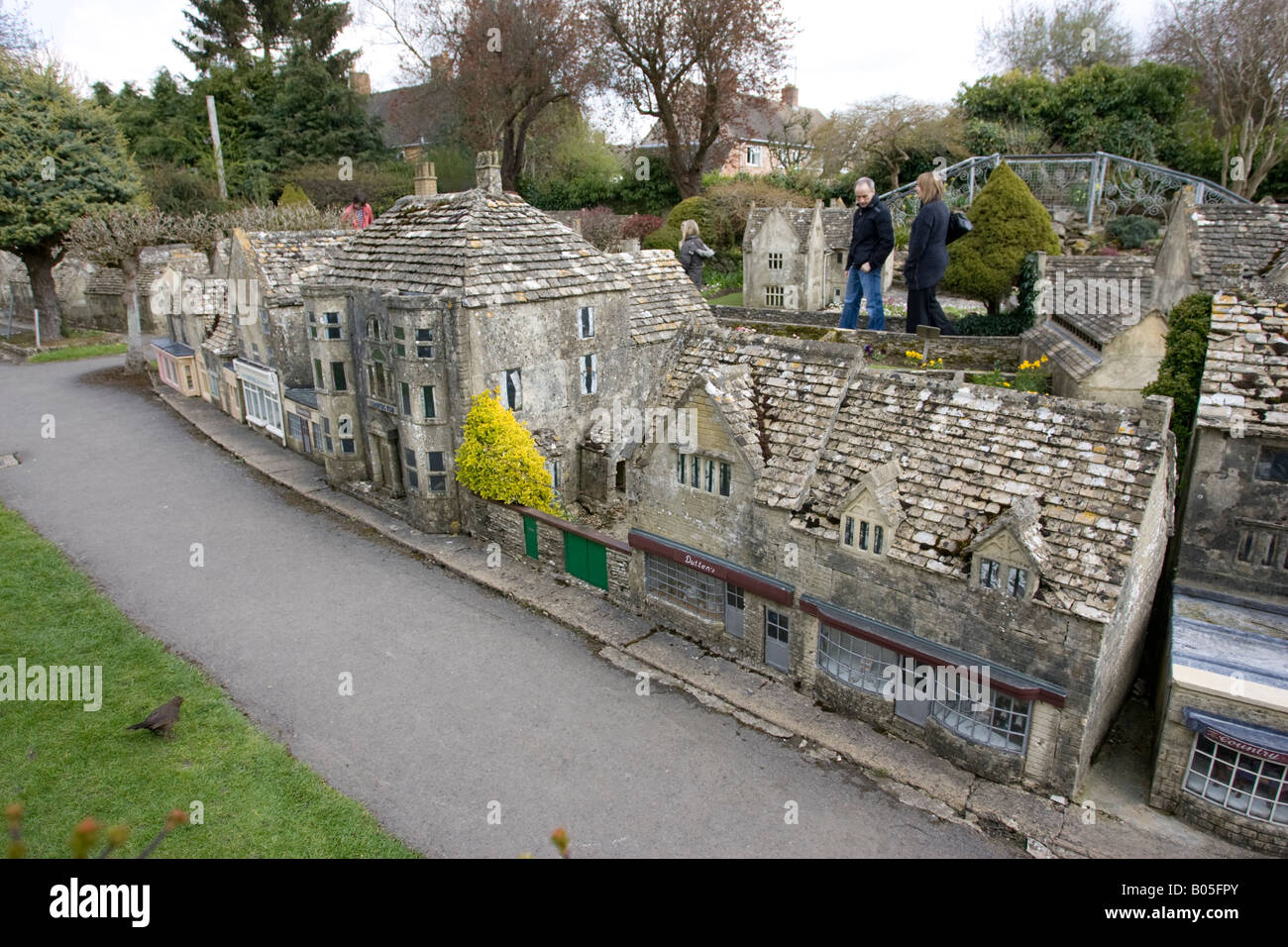 Visitors admiring miniature Cotswold houses model village Bourton on the Water UK Stock Photo