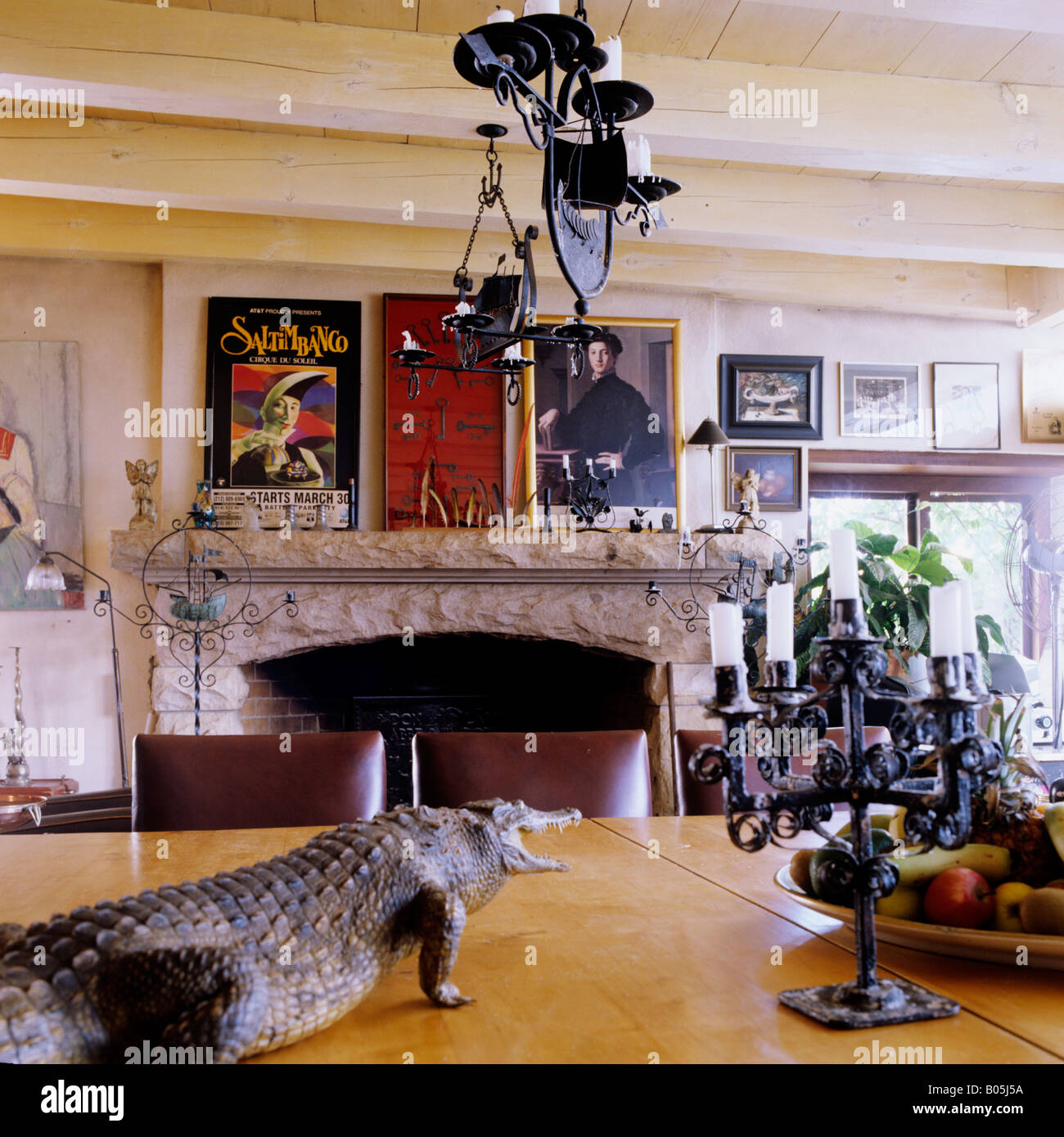 view across dining table with a stuffed baby crocodile in the kitchen of a South African Cape Dutch homestead Stock Photo