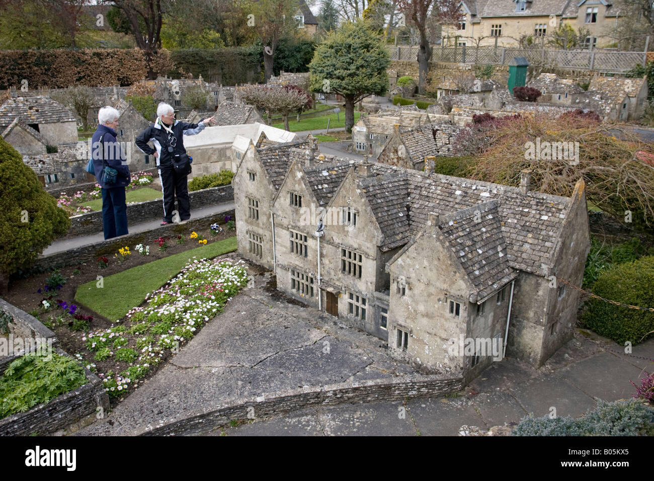 Visitors admiring miniature Cotswold houses model village Bourton on