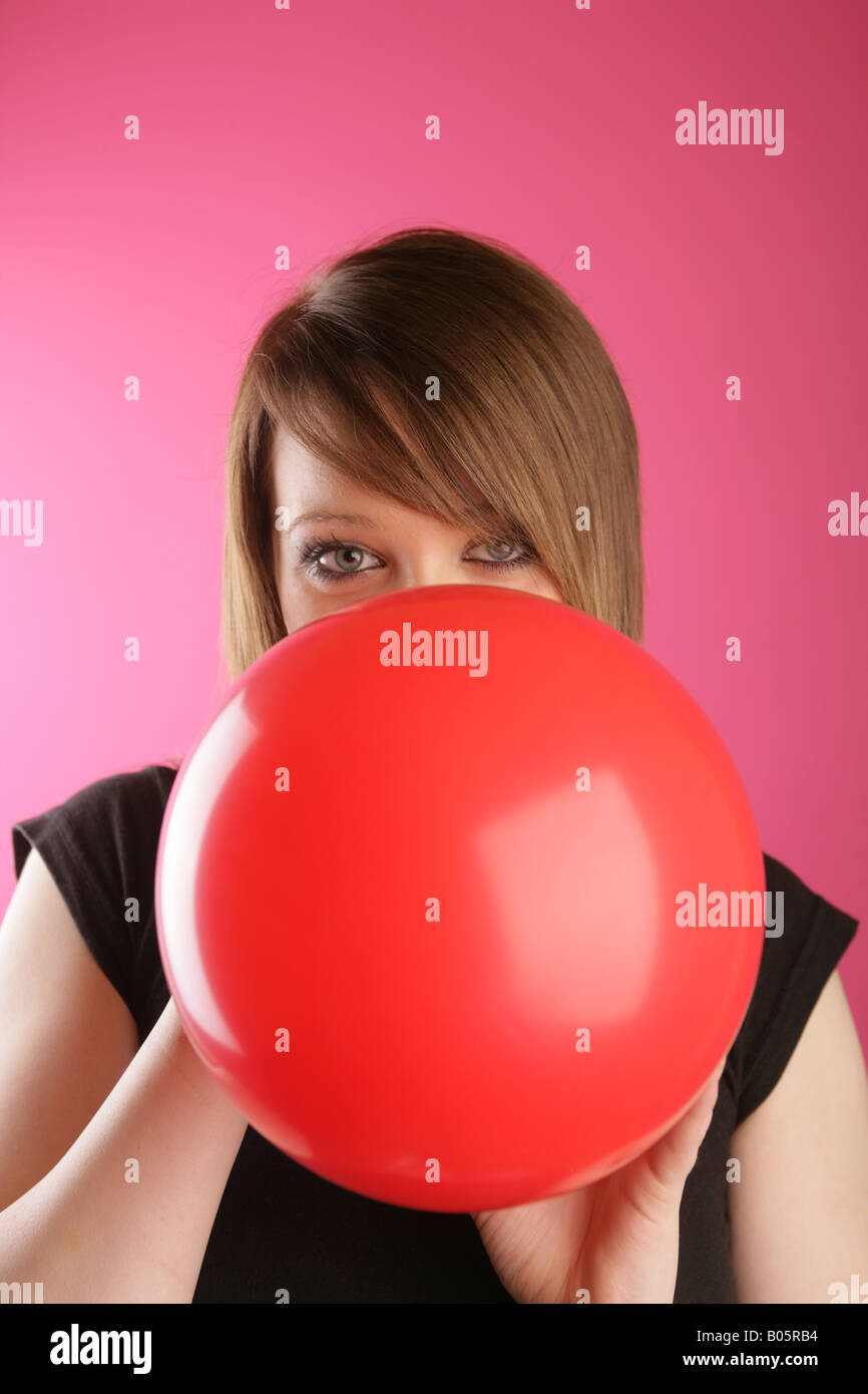 Teen girl blowing up balloon hires stock photography and images Alamy