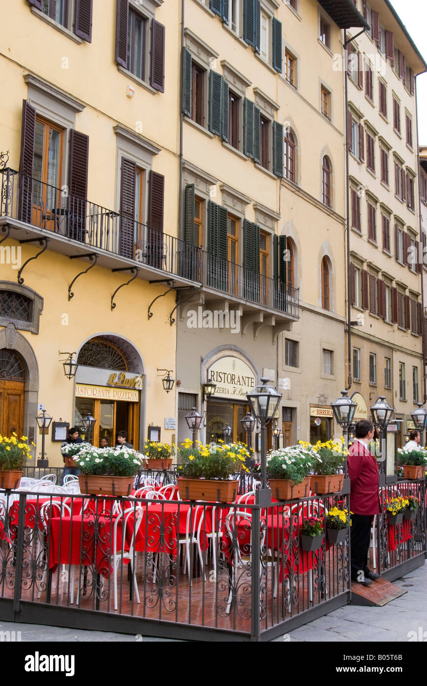 Outdoor cafe with red tablecloths ready for customers in Piazza della Signoria in Florence Italy Stock Photo