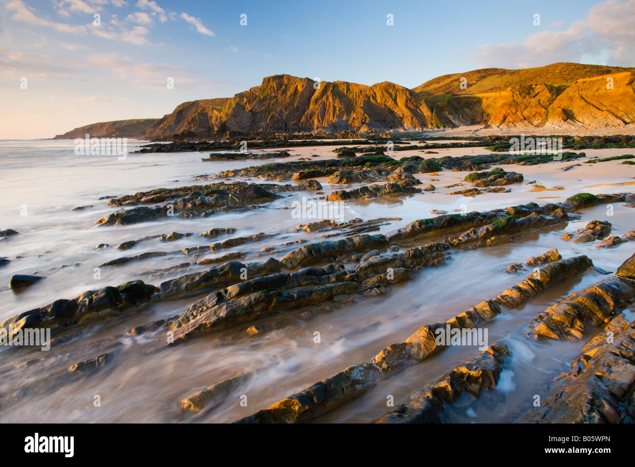 Eroded ledges exposed at low tide Sandymouth North Cornwall Stock Photo