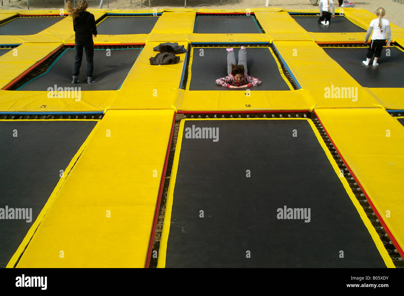 Kids children jumping happy on yellow trampoline outdoors in Scheweningen Den  Haag Netherlands Stock Photo - Alamy