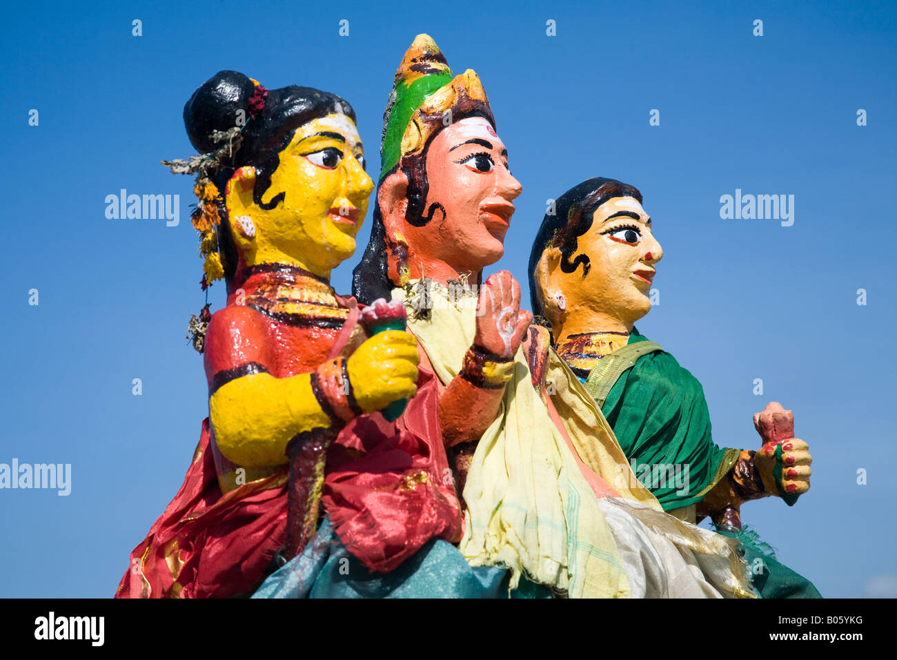 Colourful religious statue depicting three women at a Hindu Shrine, Tamil Nadu, India Stock Photo