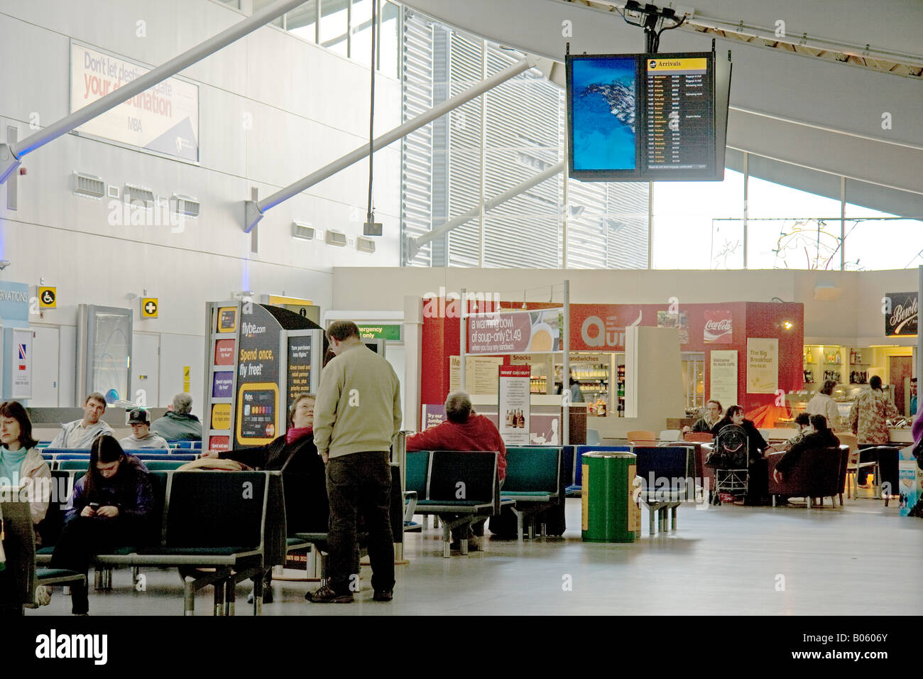 Interior view of Southampton regional airport main building including passenger seating shops arrival board and advertising Stock Photo