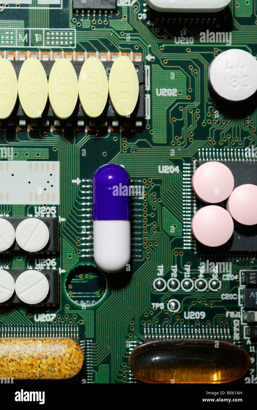 'drug and vitamin pills on circuit board' Stock Photo