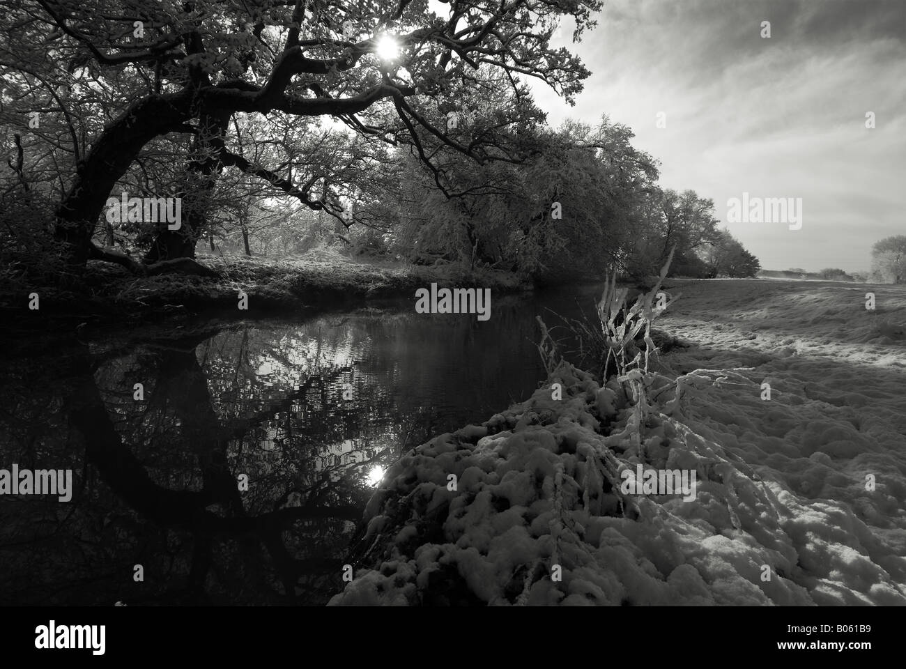 Monochrome image looking along the River Stour on a snowy day, Honington, Warwickshire, Engalnd, UK. Stock Photo