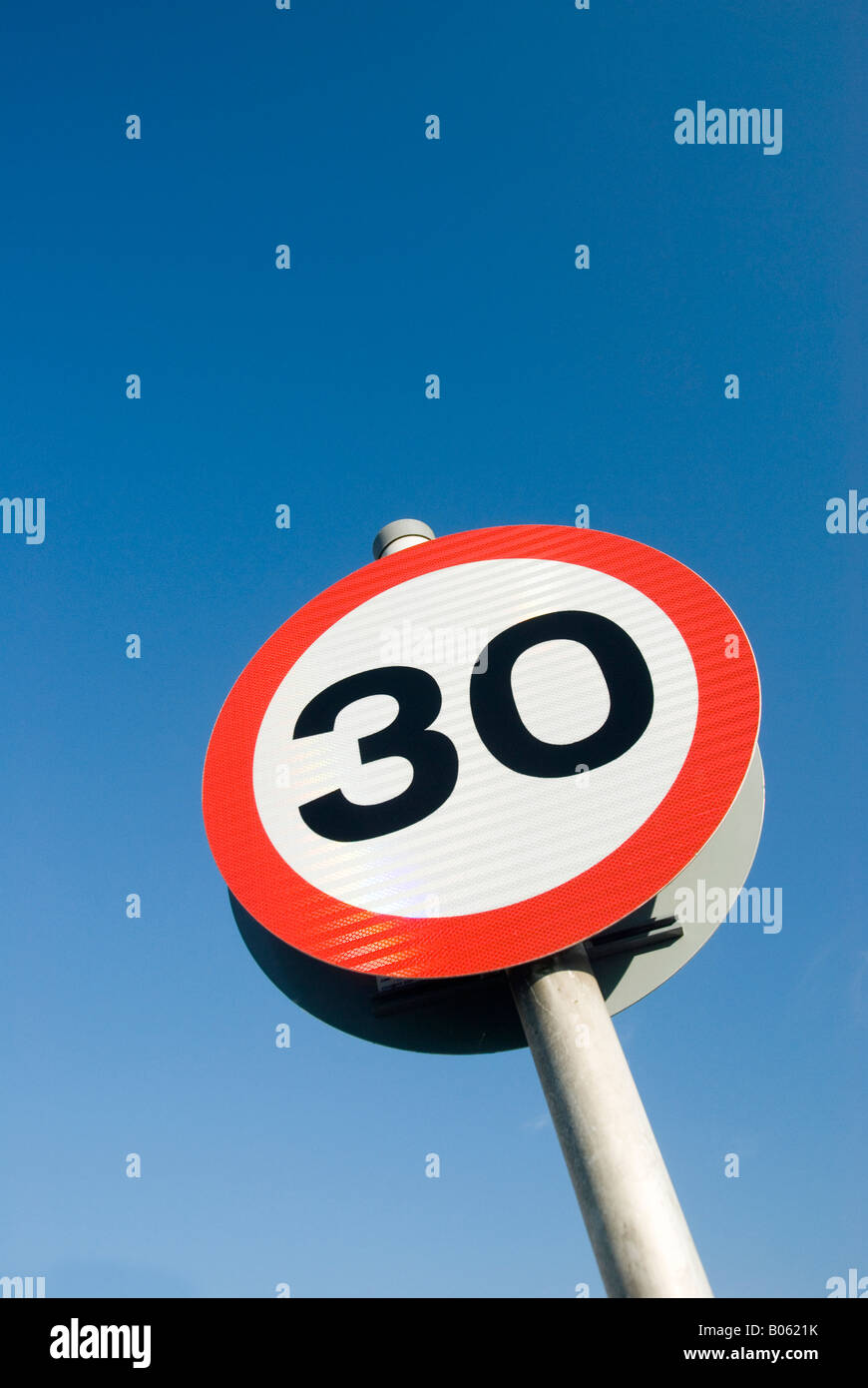 30 mph speed limit sign against blue sky background Stock Photo