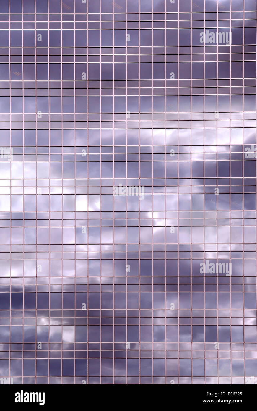 Reflection of a cloudy sky in glass wall of an office building Stock ...