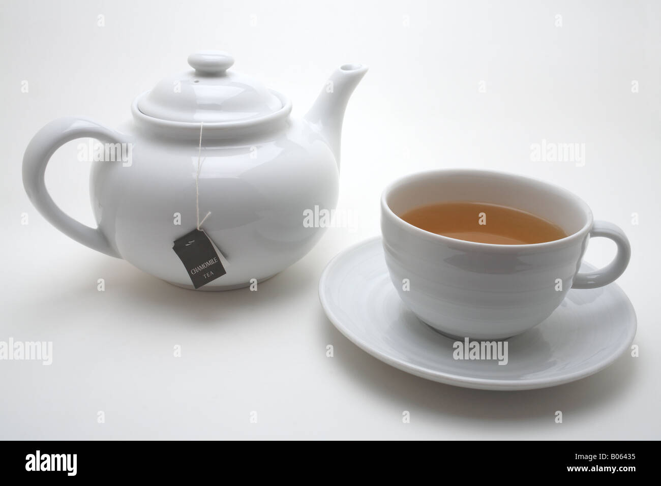 White teapot and cup and saucer with Chamomile teabag Stock Photo Alamy