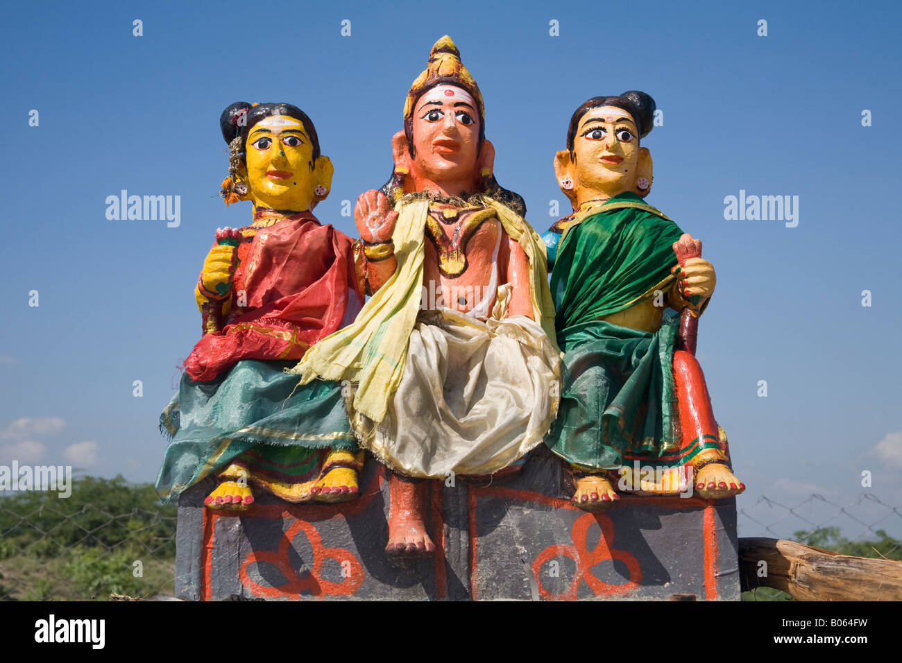 Colourful religious statue depicting three women at a Hindu Shrine, Tamil Nadu, India Stock Photo