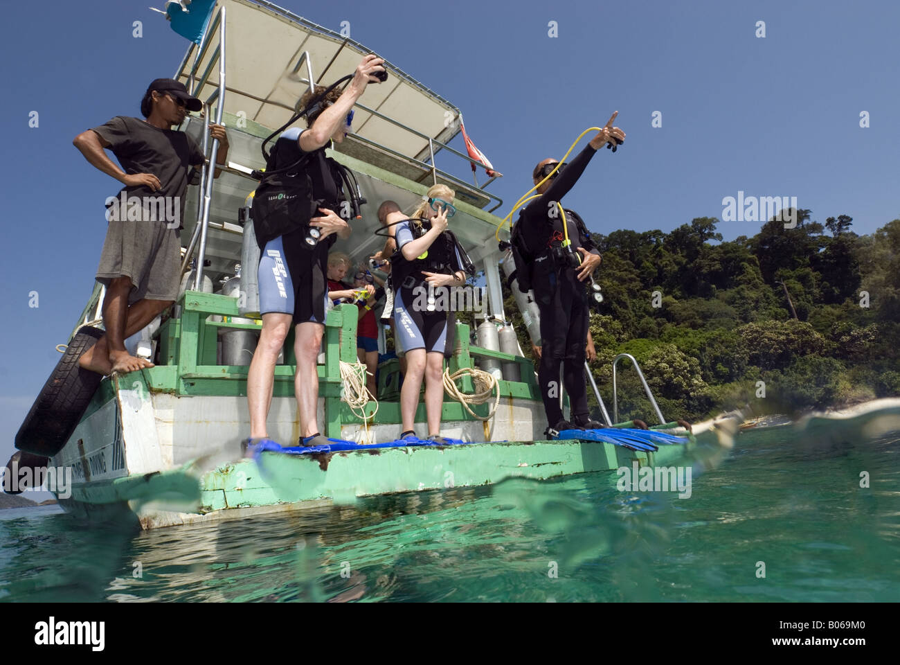 Divers getting ready for entering the water on a diving platform at the