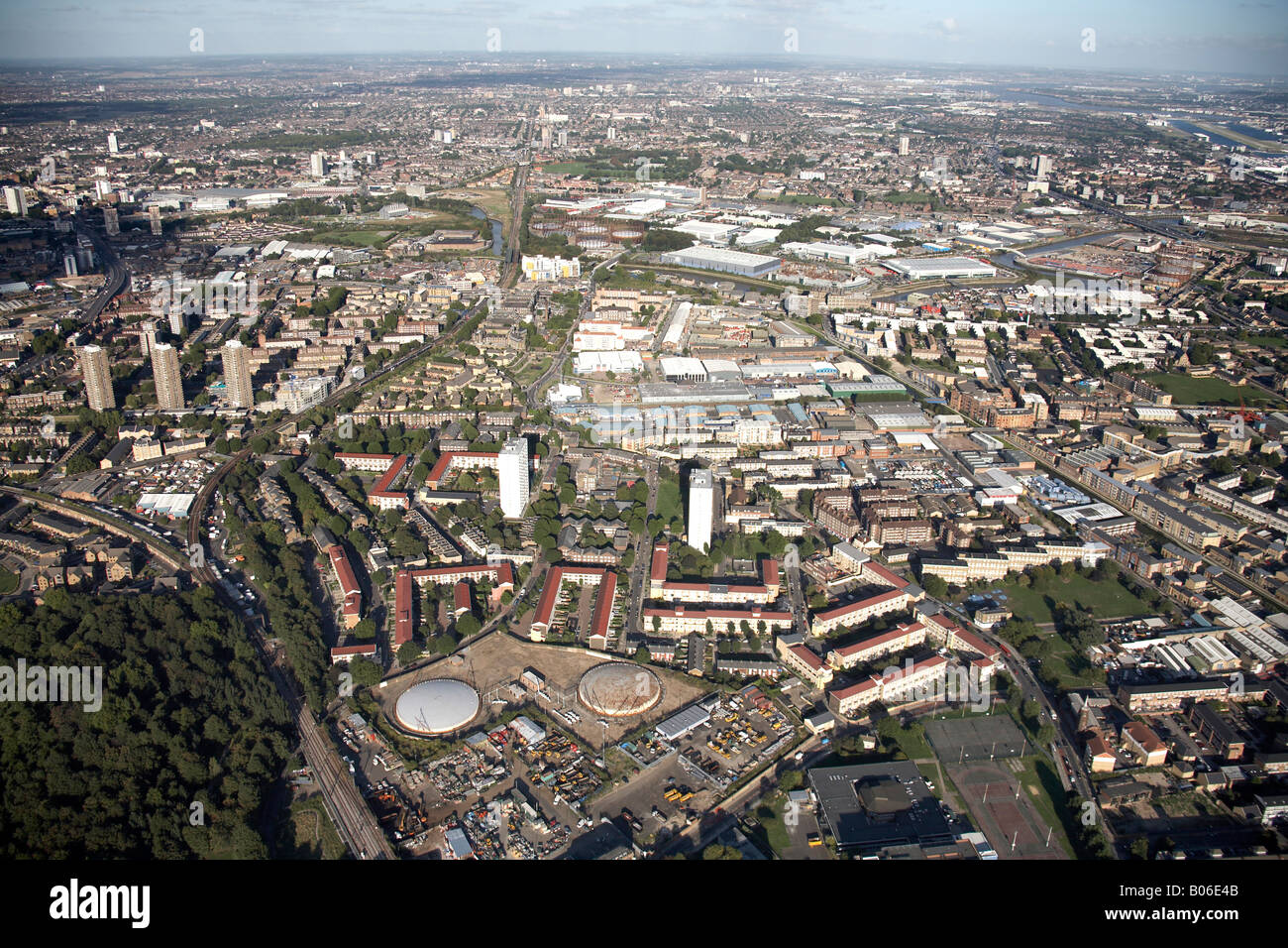 Aerial view north east of suburban housing tower blocks DLR railway lines Bow Triangle Business Centre Limehouse Cut Bromley Lon Stock Photo
