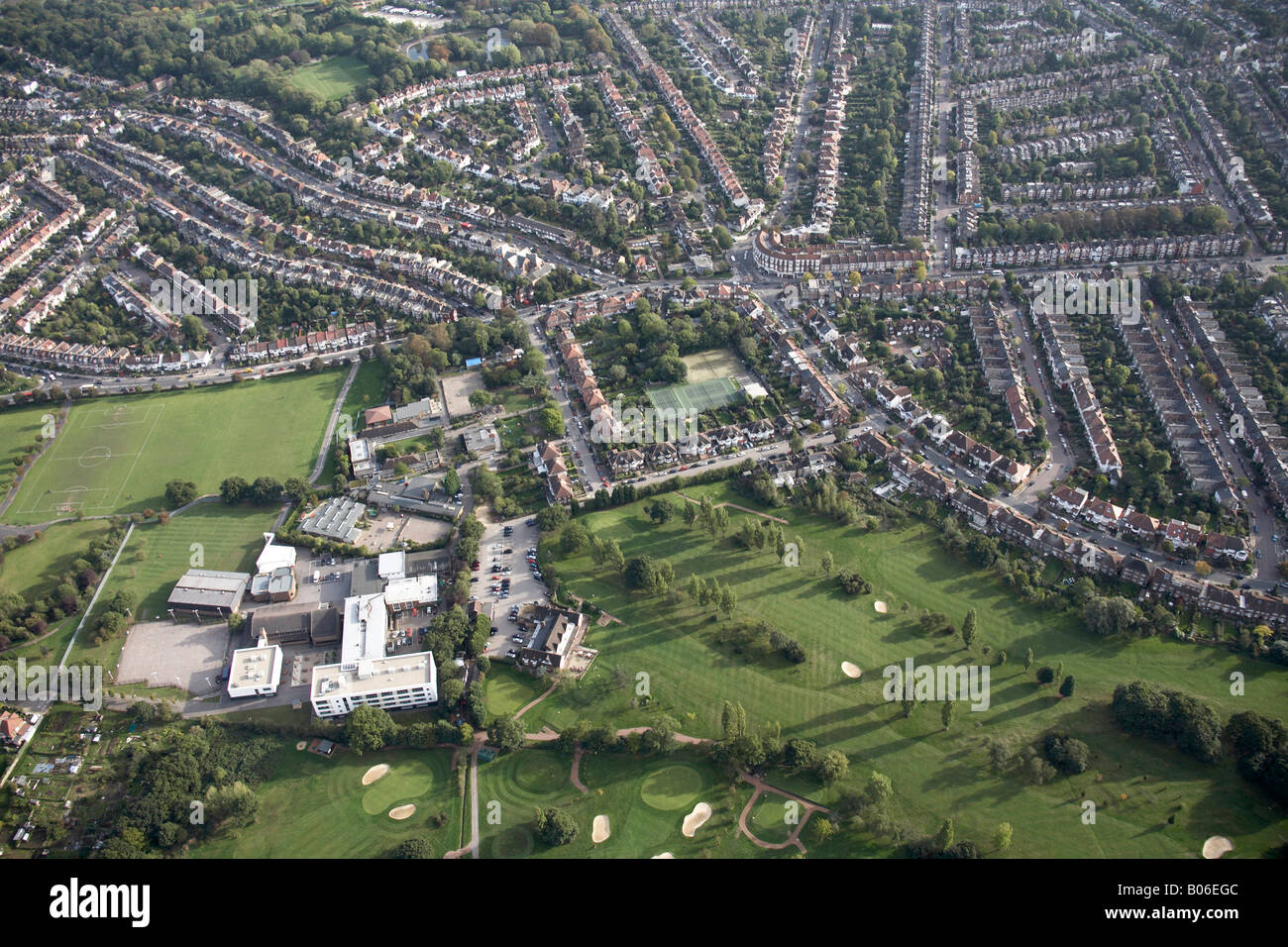 Aerial view south east of Muswell Hill Golf Course Alexandra Park School tennis courts suburban houses Grosvenor Road London N10 Stock Photo