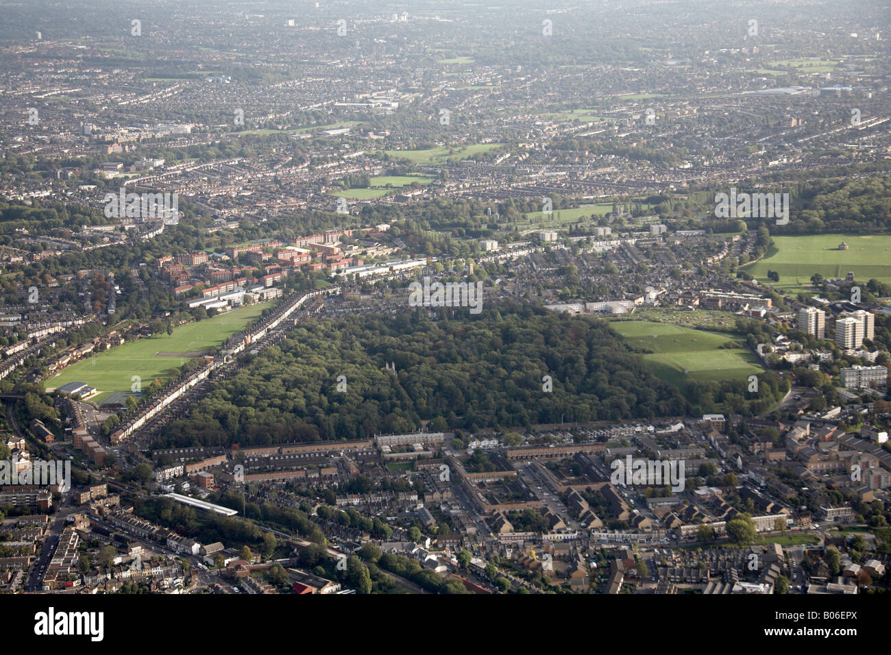Aerial view south east of Nunhead Cemetery Ivydale Road playing fields suburban houses tower blocks Brockley London SE15 SE4 UK Stock Photo