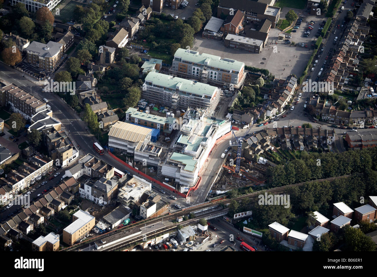 Aerial view south east of Queens Road train station railway line suburban houses shops Peckham London SE15 England UK Stock Photo