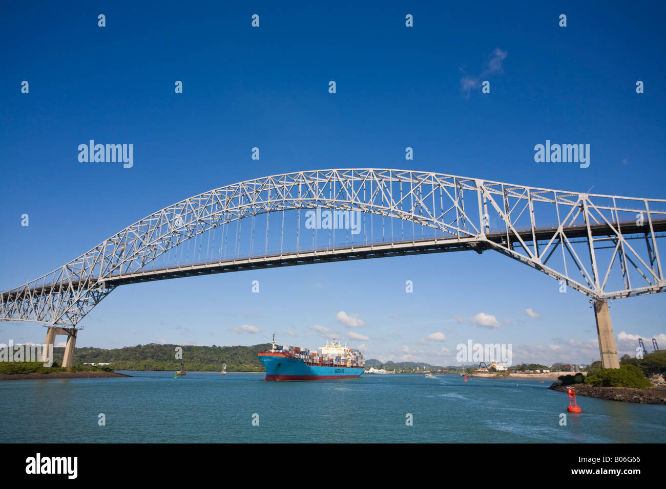Panama, Panama city, Container ship sailing under the Bridge of the Americas Stock Photo