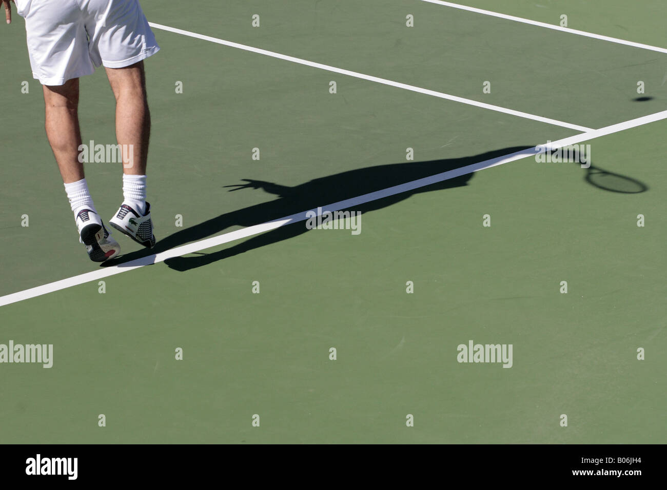 Shadow thrown by Albert Costa as he serves during the final of the Tenerife Senior cup at Abama Stock Photo