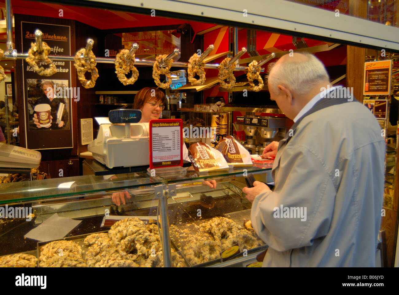 Europe, Germany, Cologne, Merzenich pastry pretzel sales person and ...