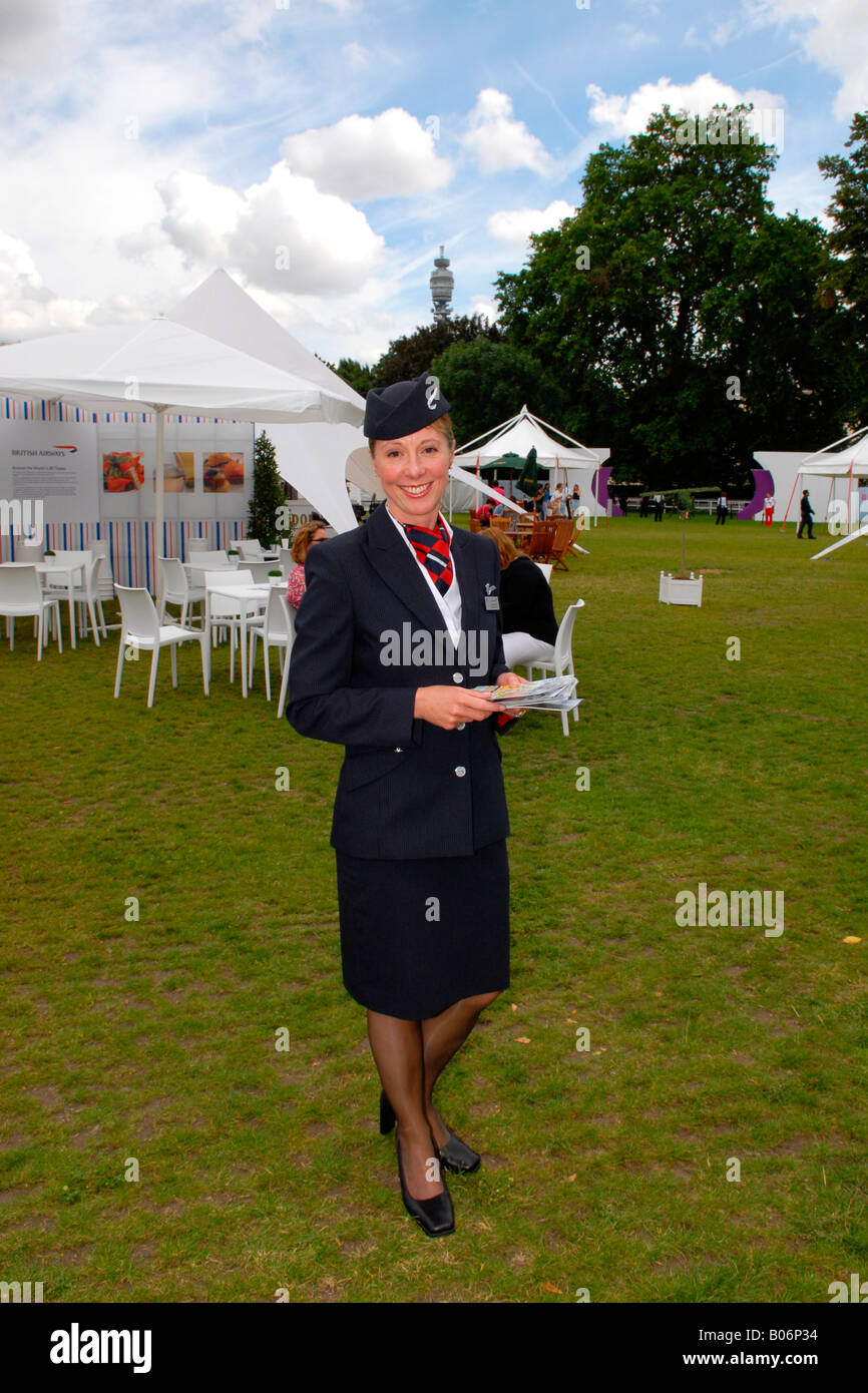 Taste of London Show , pretty smiling BA crew air hostess with the BT telecom tower in background Stock Photo