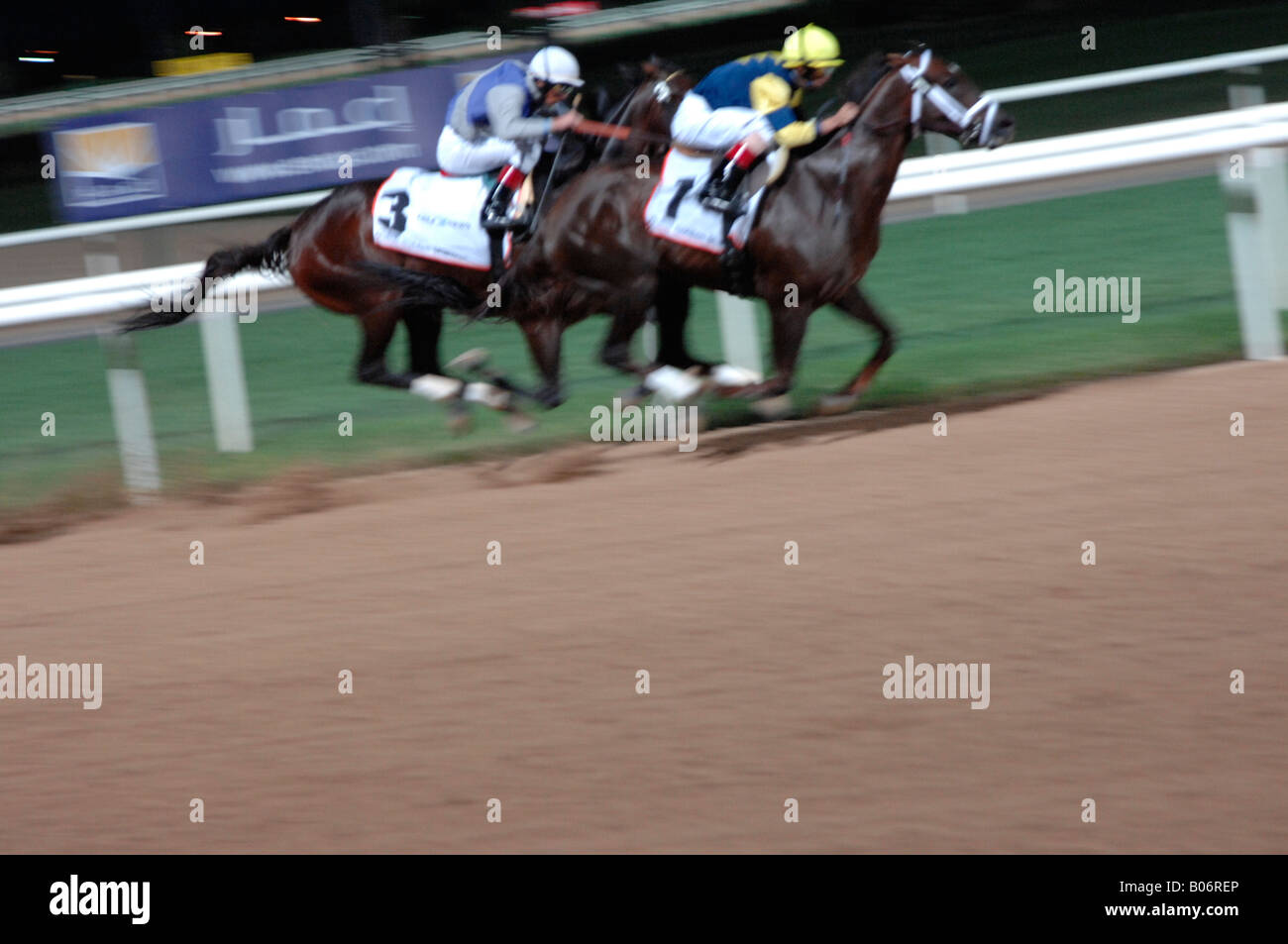 Abstract horse racing on dirt at Nad el Sheba race course Dubai Stock Photo