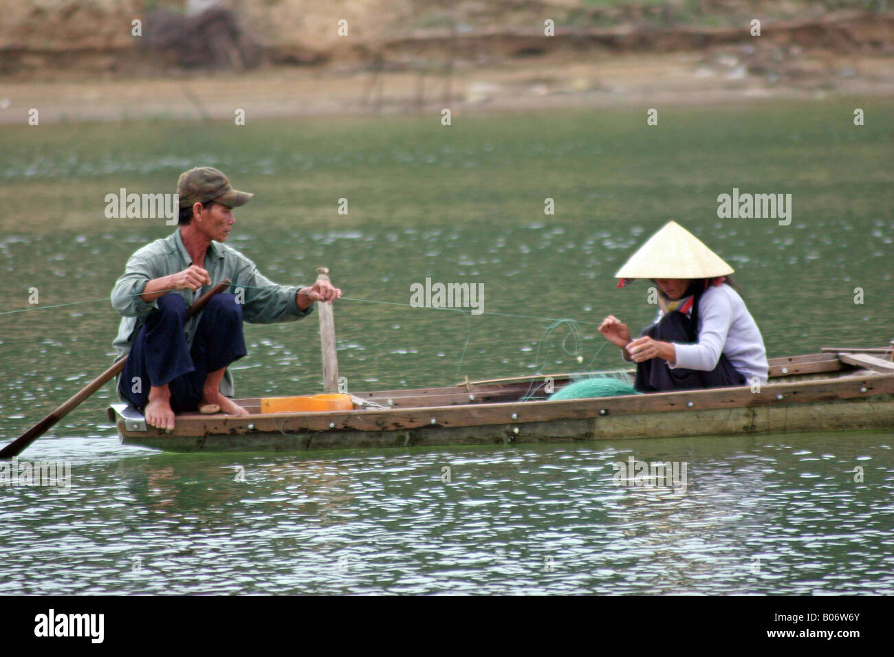 Vietnam couple repair nets Stock Photo
