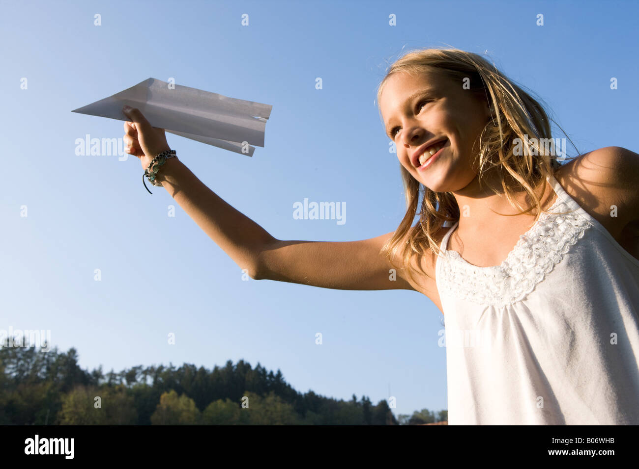 Gril playing with paper airplane Stock Photo