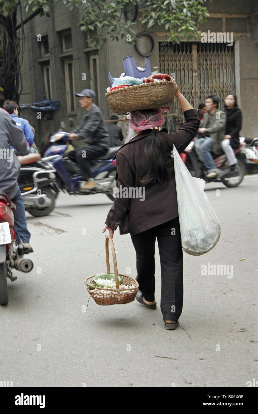 Hanoi Woman with baskets Stock Photo