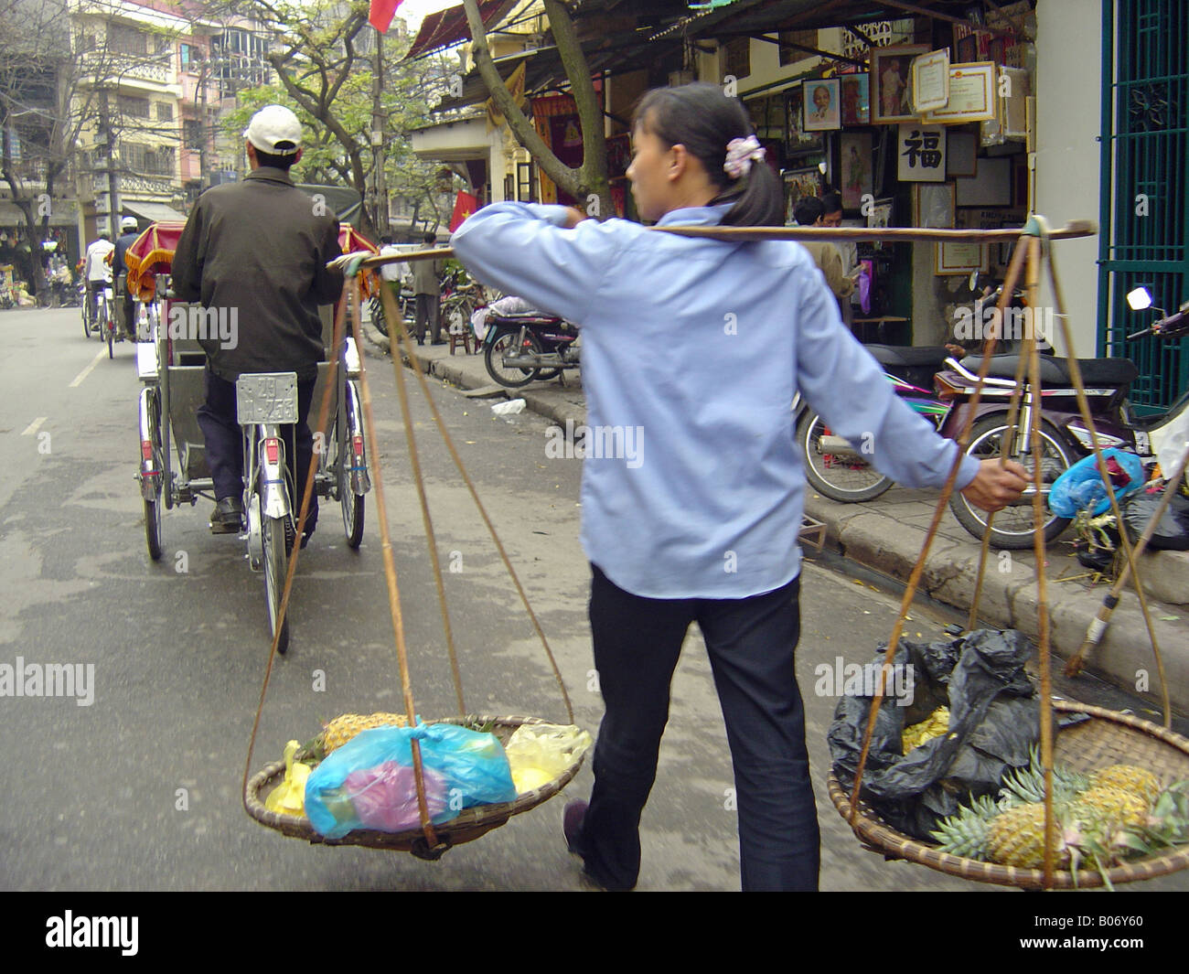 Hanoi Woman with yoked baskets Stock Photo