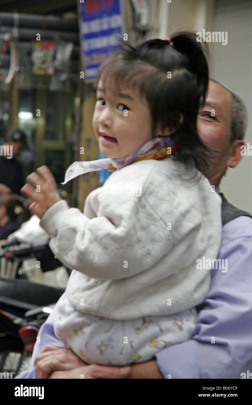 Hanoi girl with grandfather Stock Photo