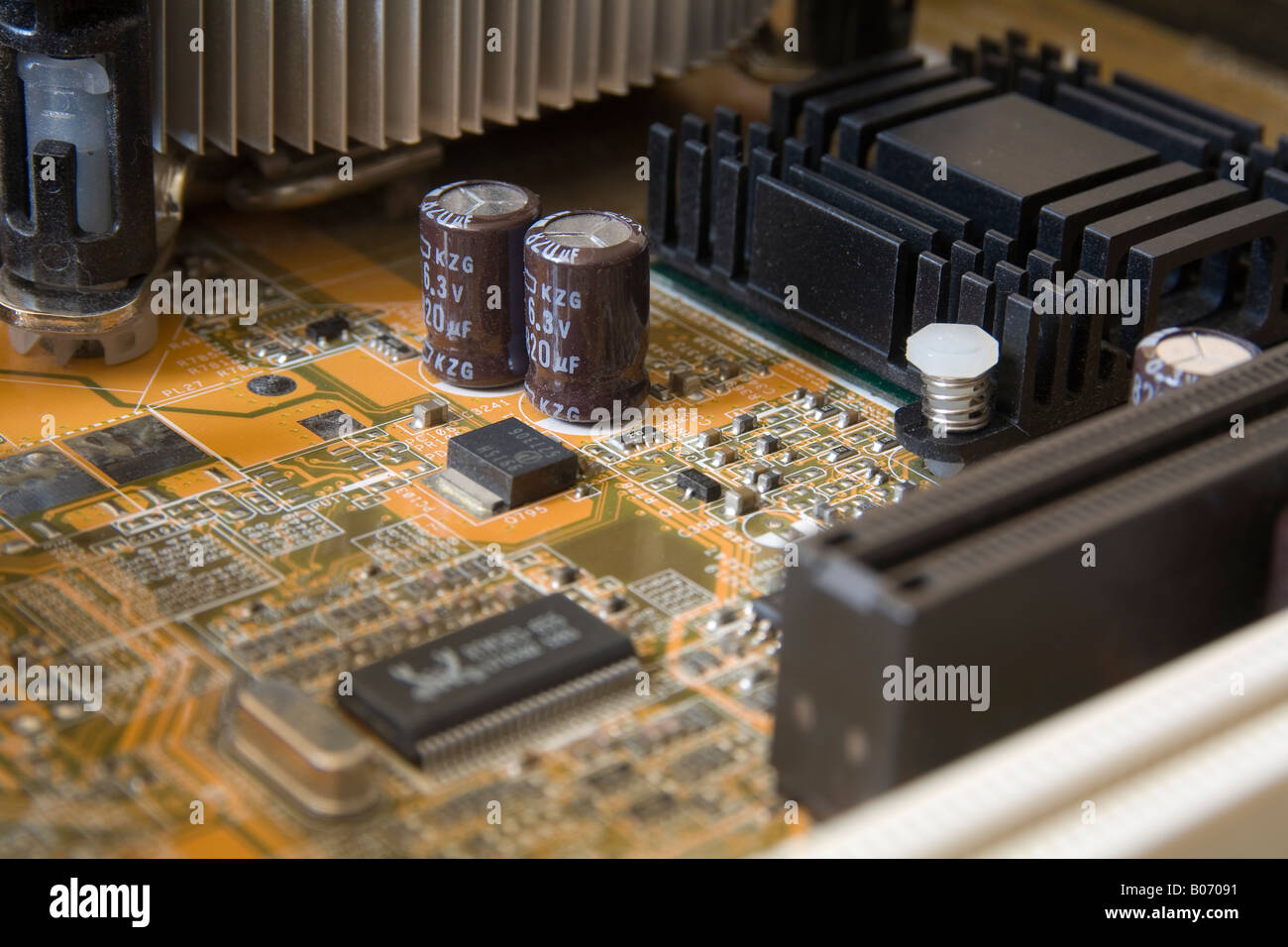 twin electrolytic capacitors stand tall on the electronic motherboard