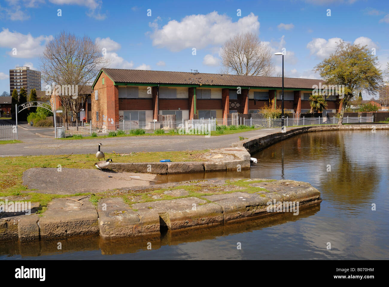 Boarded houses beside the Royle Basin of the Rochdale Canal in Lostock