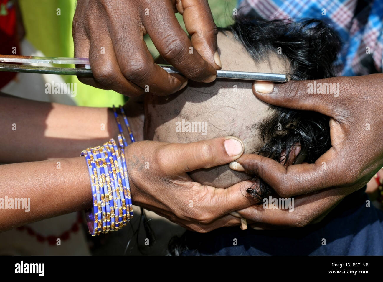 Young Hindu having his head shaved during the Namakaran Ceremony, Tamil