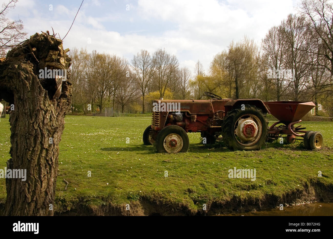 Red old tractor on the land Stock Photo - Alamy