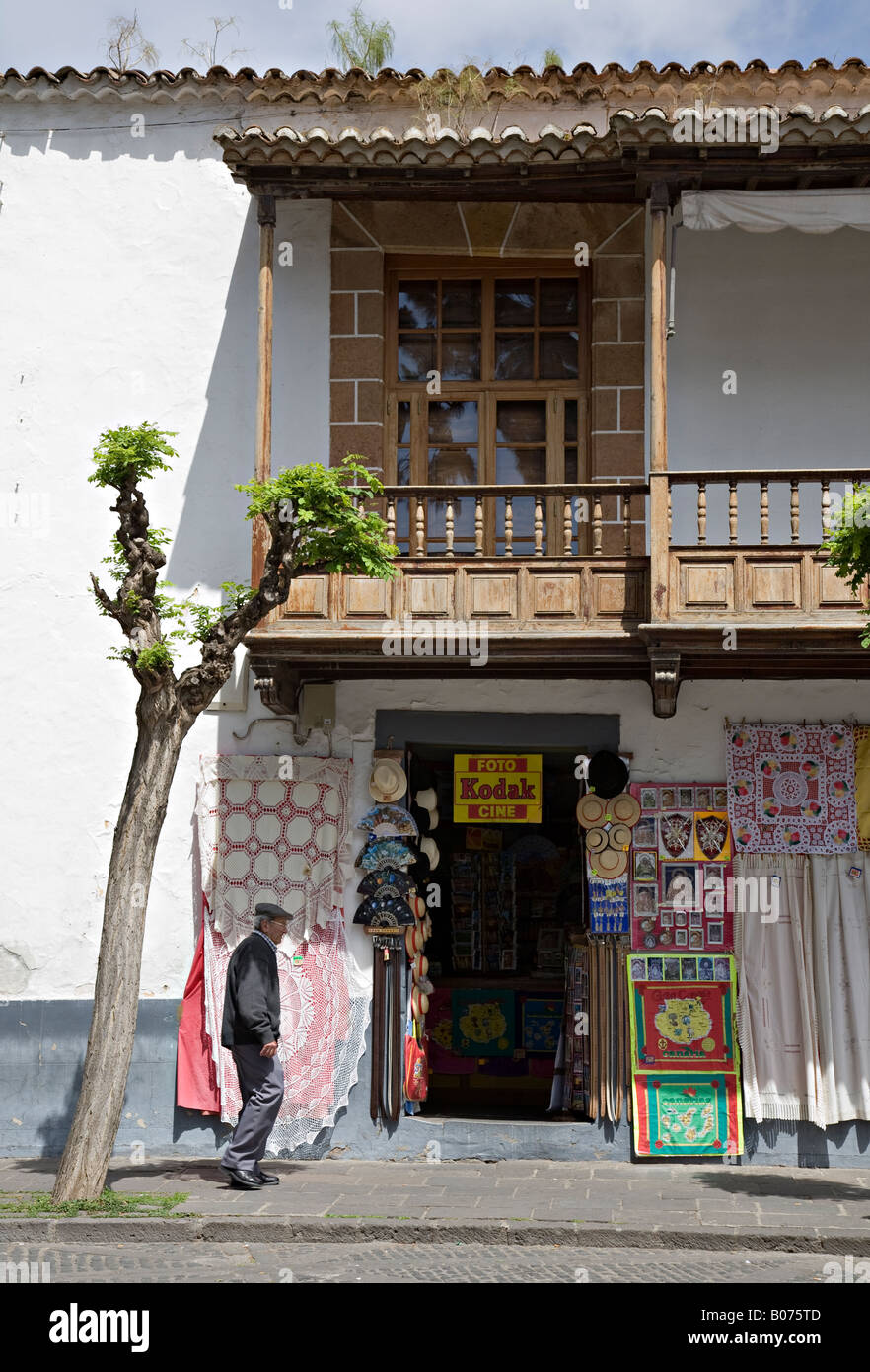 Old man walking past shop with traditional Canarian balcony and selling lace Teror 'Gran Canaria' Spain Stock Photo