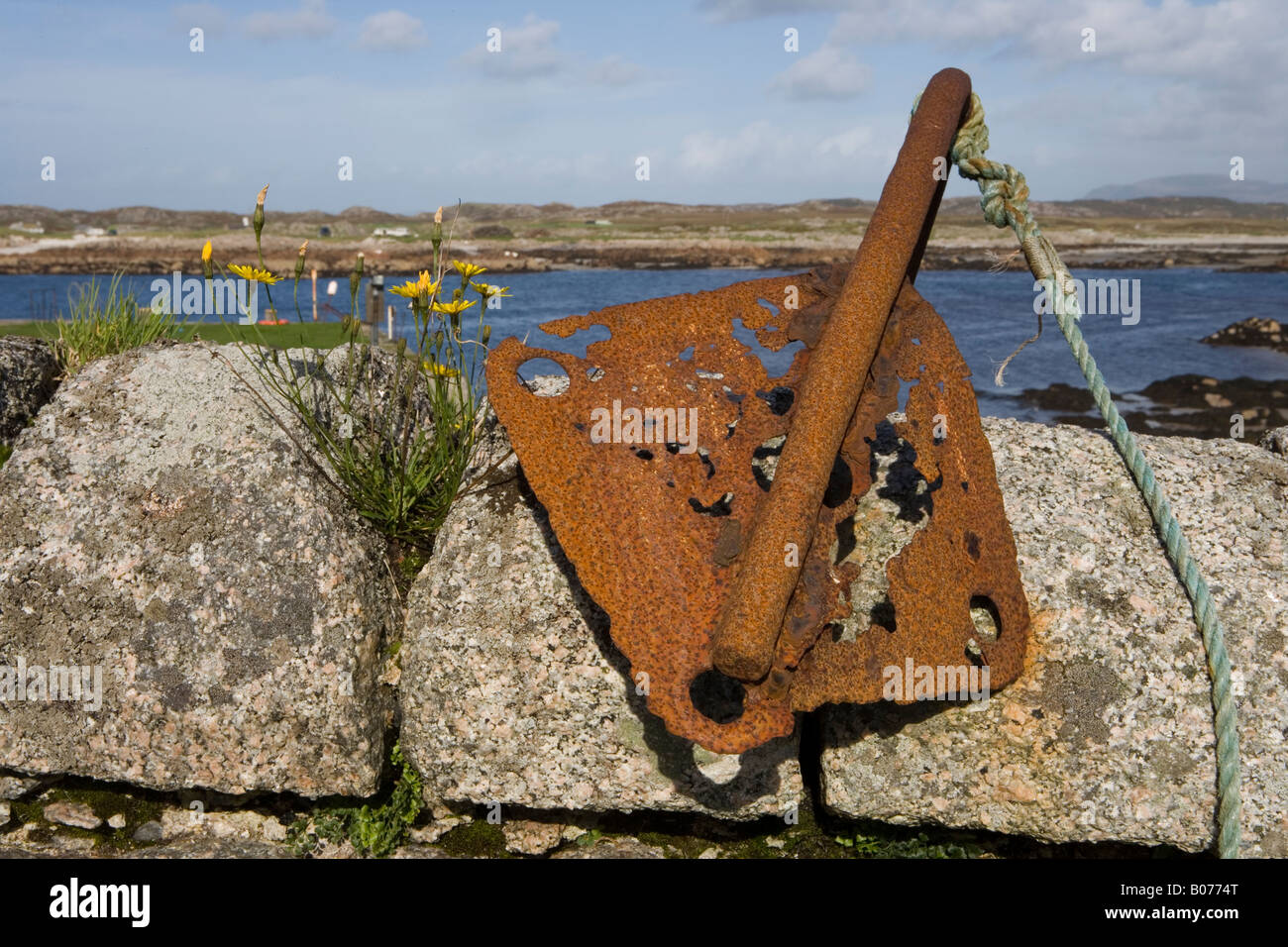 Rusty anchor on wall, Erraid, Isle of Mull, Scotland, UK Stock Photo